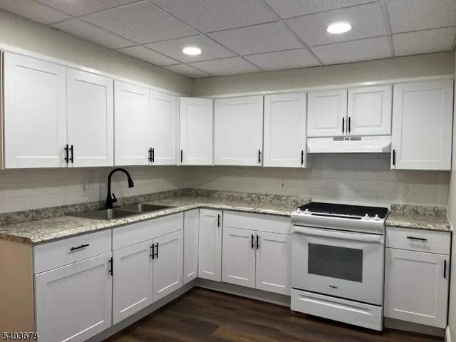 a kitchen with appliances cabinets and a sink