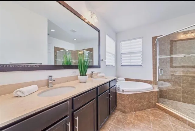 a bathroom with a bathtub and a shower