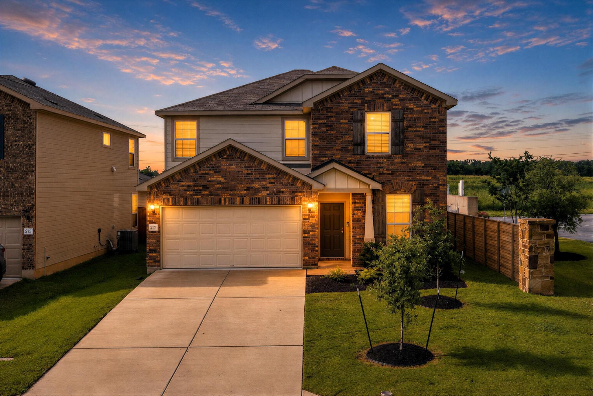 217 Innisfree Road Jarrell, TX 76537 - Photo 2 of 39 Front of the house features front entry 2 car garage.