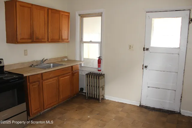 a kitchen with a sink cabinets and a window