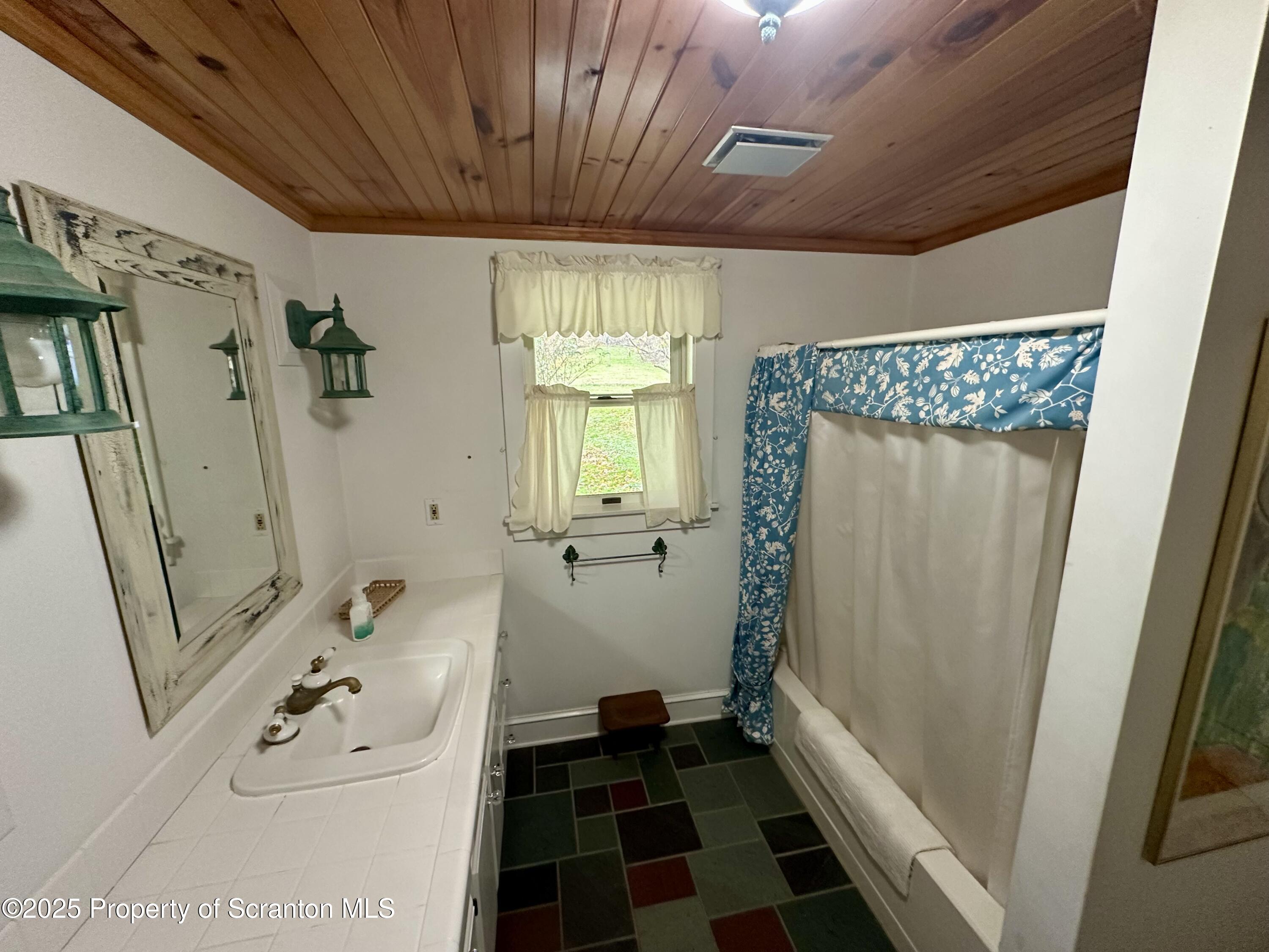 1033 Sugar Hollow Road Tunkhannock, PA 18657 - Photo 11 of 27 a bathroom with a sink and a shower