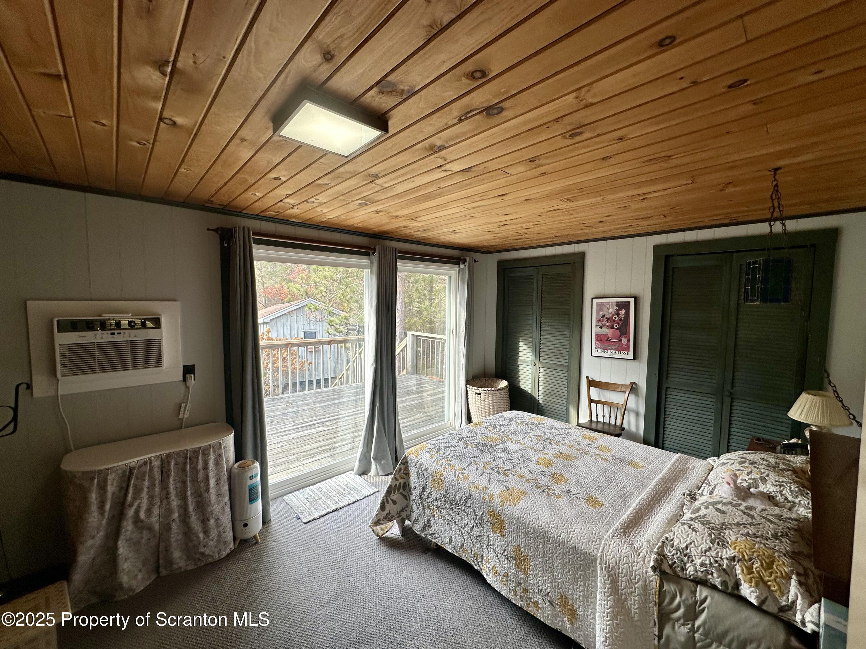 1033 Sugar Hollow Road Tunkhannock, PA 18657 - Photo 18 of 27 a bedroom with a bed and a dresser next to a window
