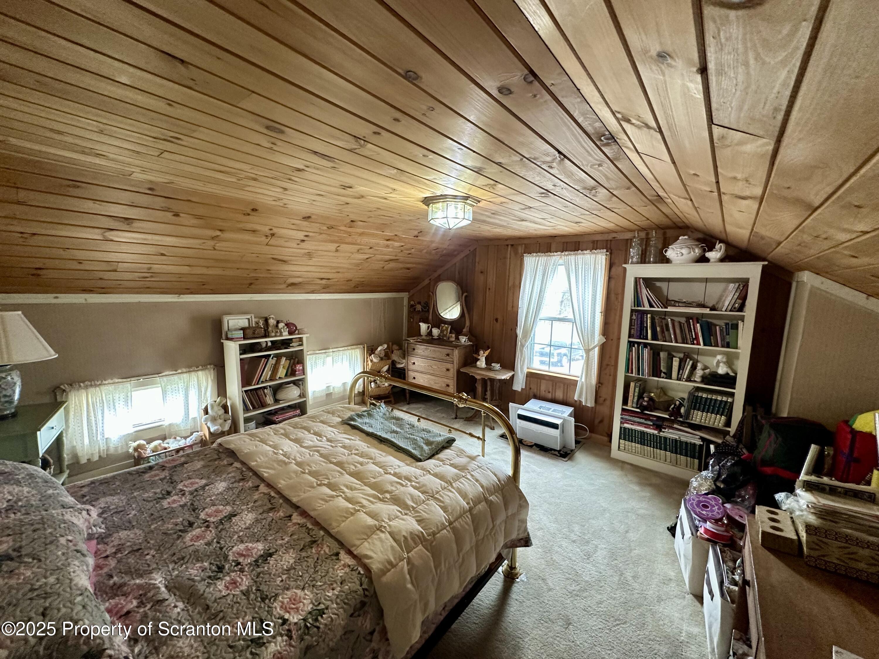 1033 Sugar Hollow Road Tunkhannock, PA 18657 - Photo 19 of 27 a bed room with a bed and a chair