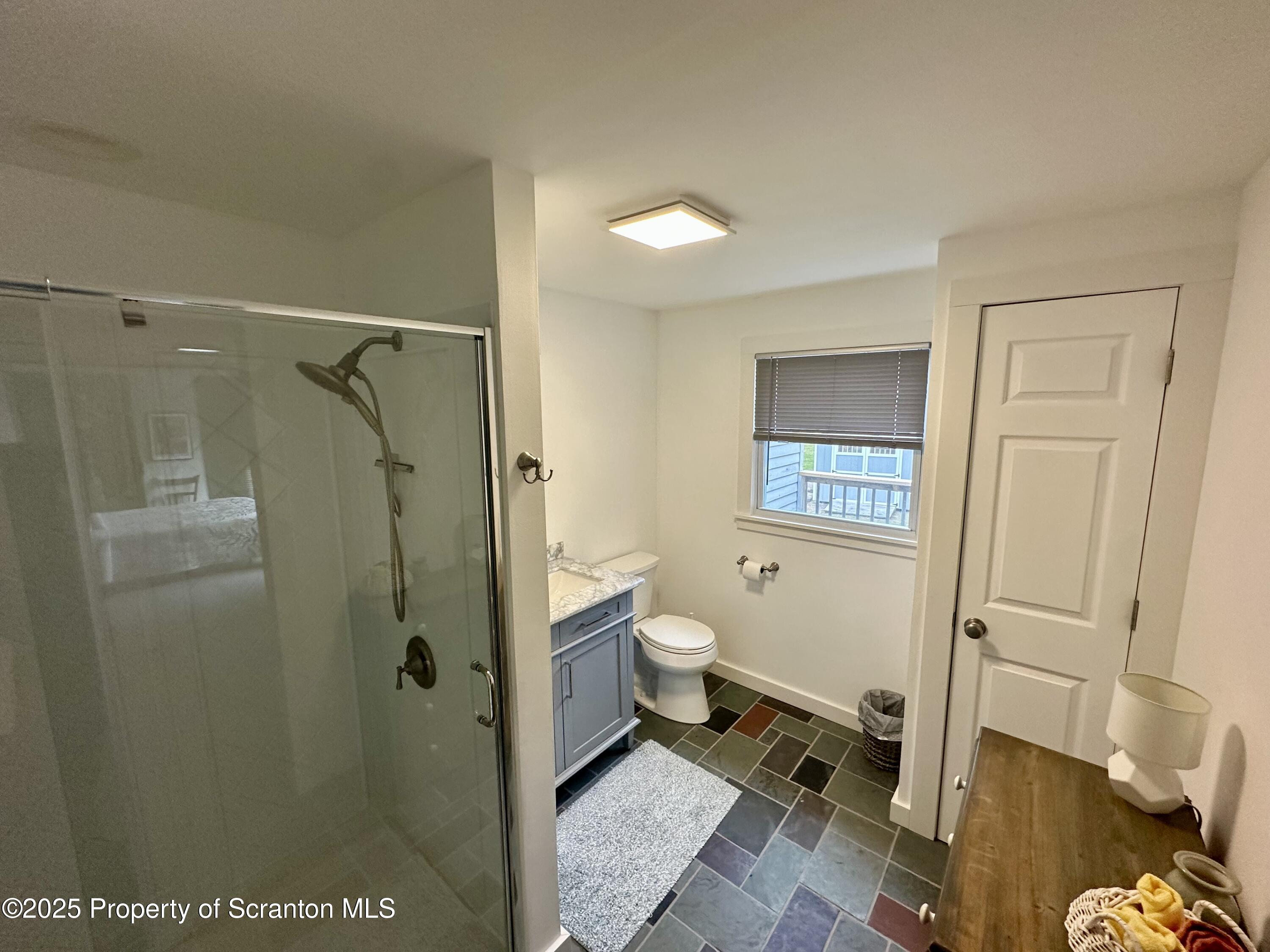 1033 Sugar Hollow Road Tunkhannock, PA 18657 - Photo 20 of 27 a bathroom with a granite countertop shower and a toilet