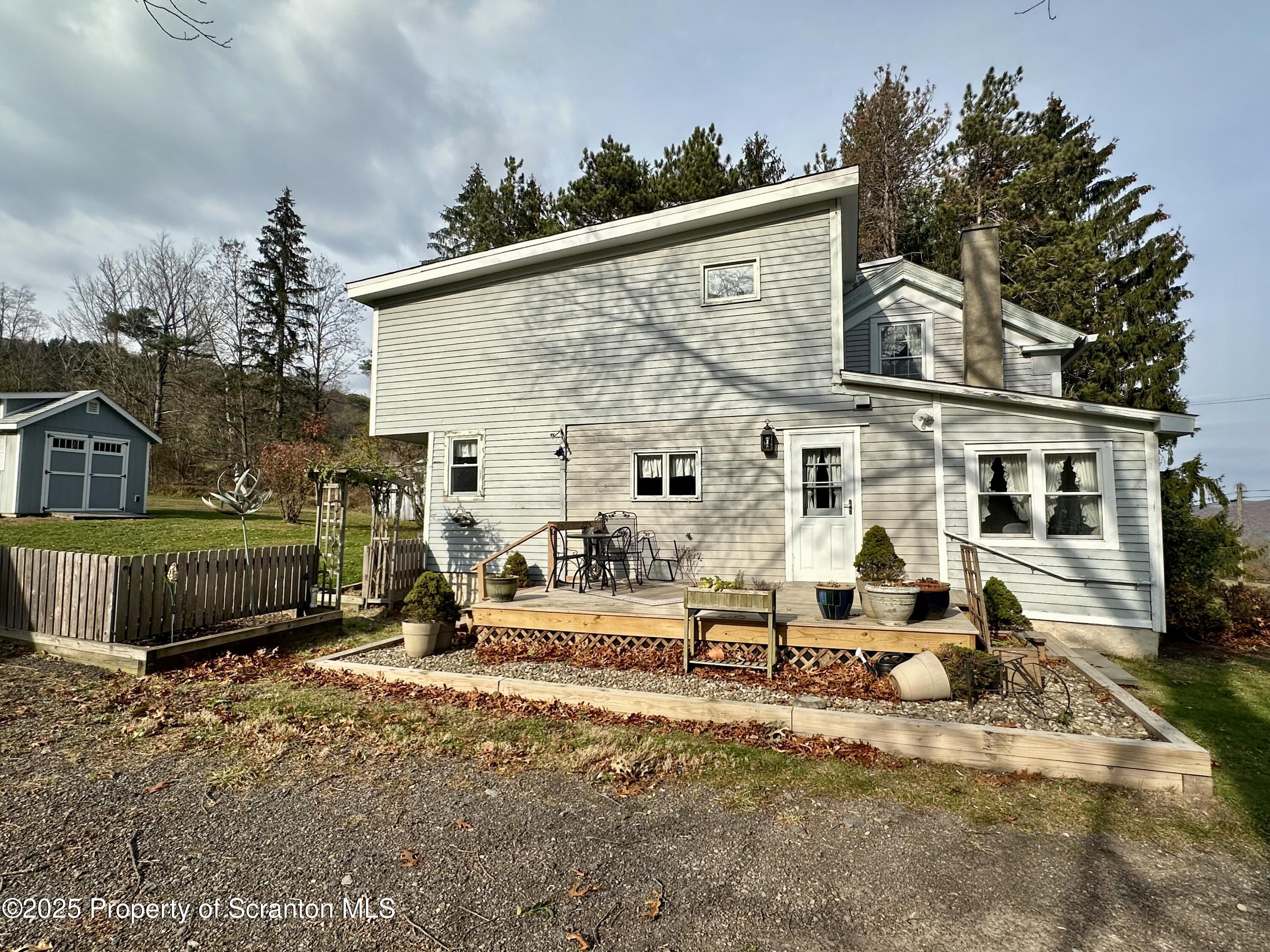 1033 Sugar Hollow Road Tunkhannock, PA 18657 - Photo 24 of 27 a view of a house with backyard and sitting area