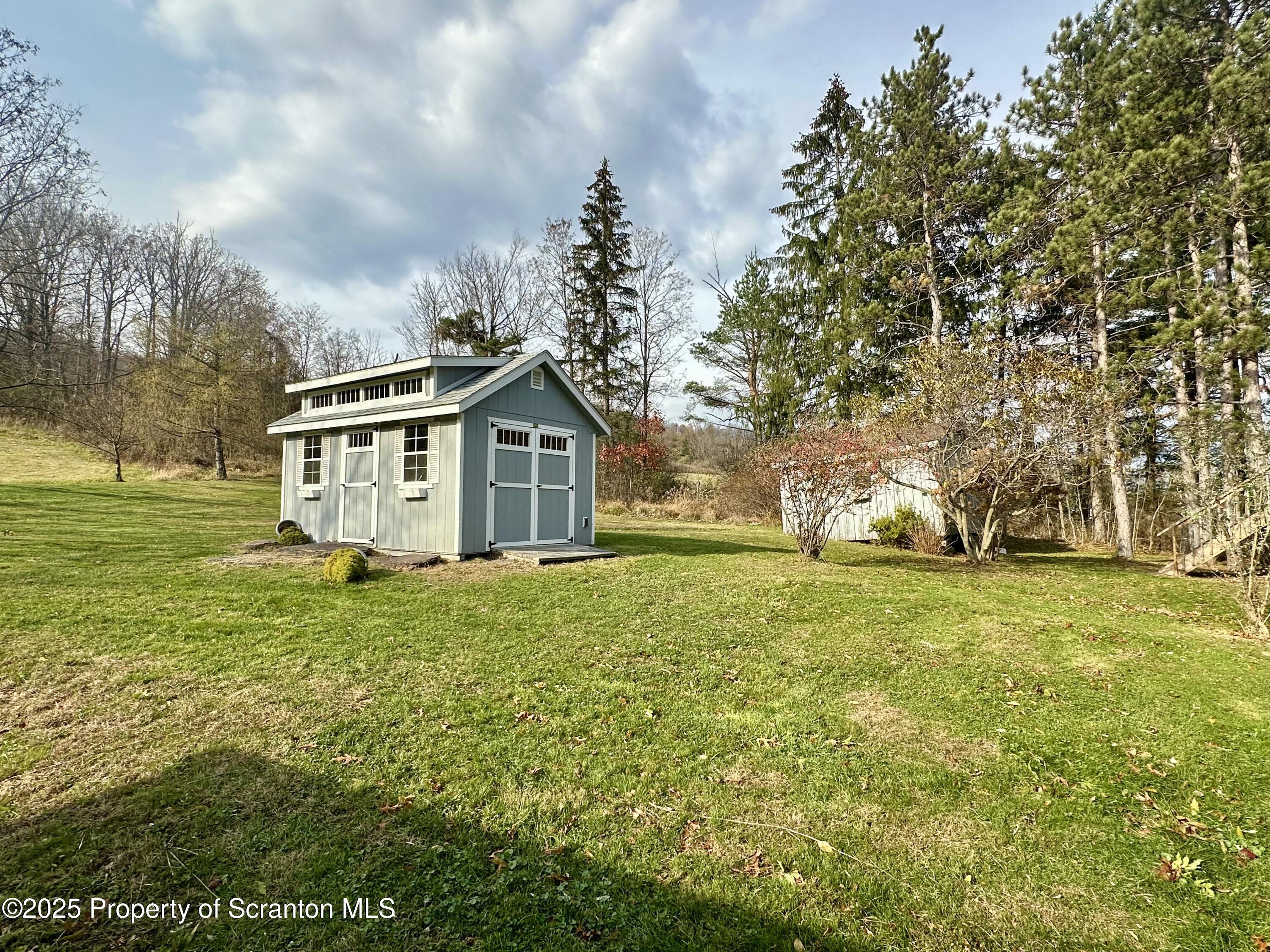 1033 Sugar Hollow Road Tunkhannock, PA 18657 - Photo 25 of 27 a front view of a house with a yard