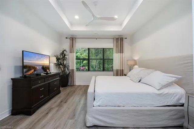 a bedroom with a large bed and a large window