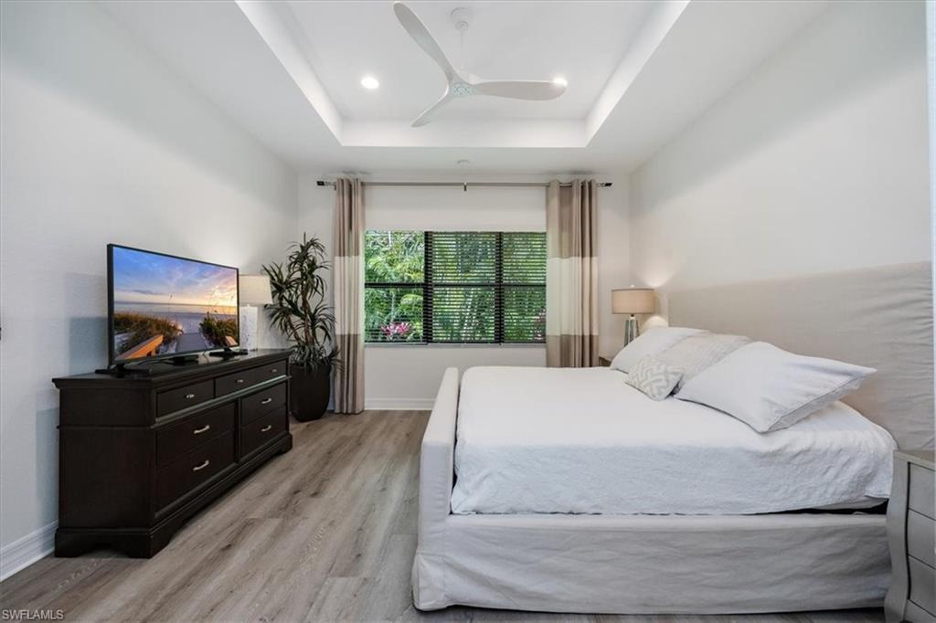 13459 Sumter Lane Naples, FL 34109 - Photo 11 of 33 a bedroom with a bed and a flat screen tv
