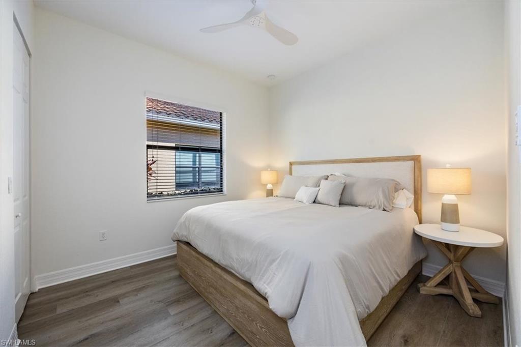 13459 Sumter Lane Naples, FL 34109 - Photo 13 of 33 a bedroom with a bed and a window