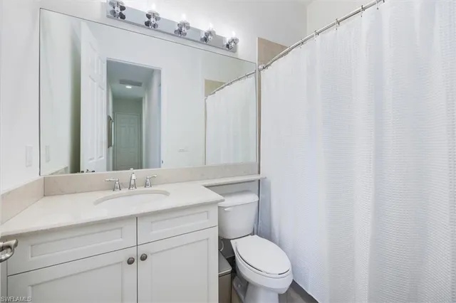 a bedroom with a bed and a lamp