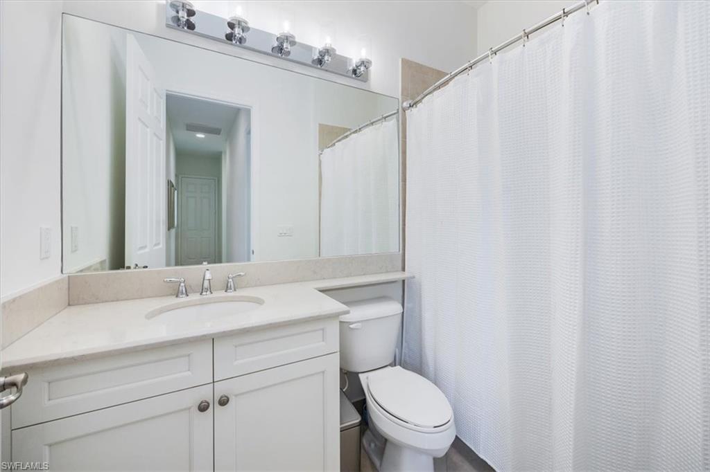 13459 Sumter Lane Naples, FL 34109 - Photo 15 of 33 a bathroom with a granite countertop sink and a mirror
