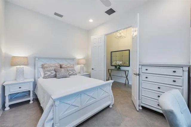 a bedroom with a large bed and a desk
