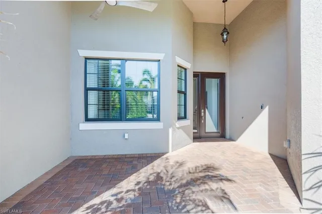 a view of a bedroom with wooden floor and a window