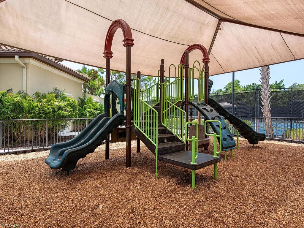 13459 Sumter Lane Naples, FL 34109 - Photo 27 of 33 a park with a slide and wooden fence