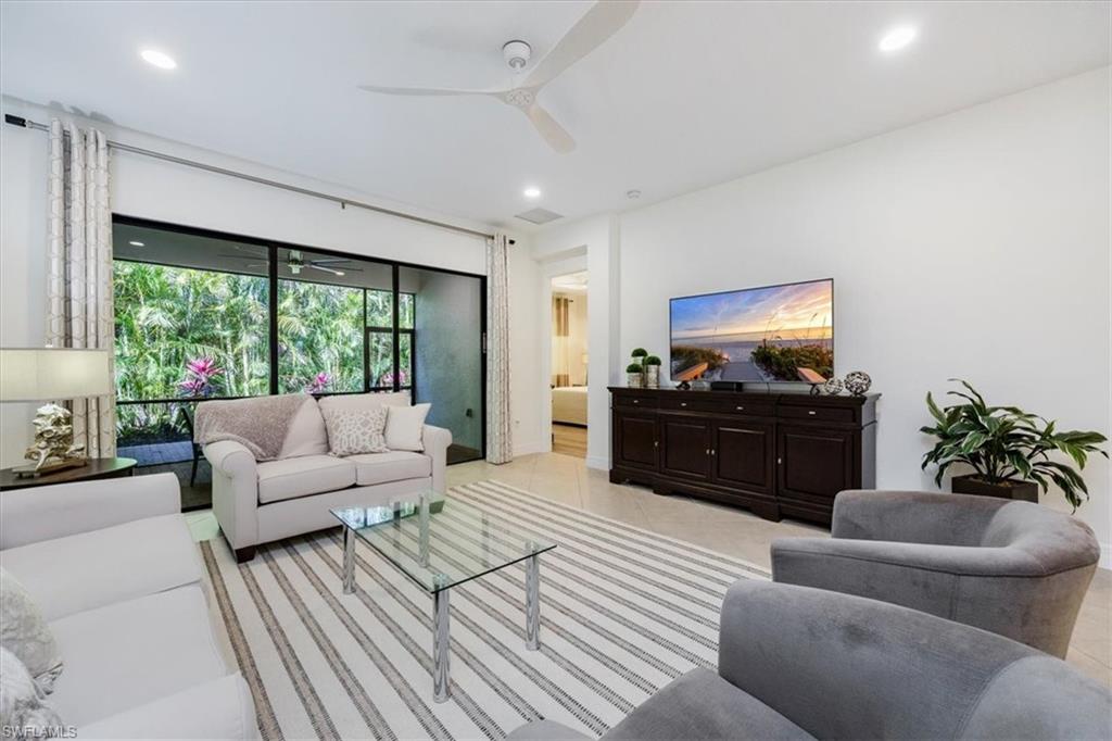 13459 Sumter Lane Naples, FL 34109 - Photo 5 of 33 a living room with furniture and a flat screen tv