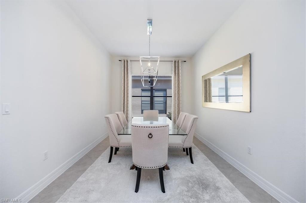 13459 Sumter Lane Naples, FL 34109 - Photo 9 of 33 a view of a dining room with furniture window and outside view