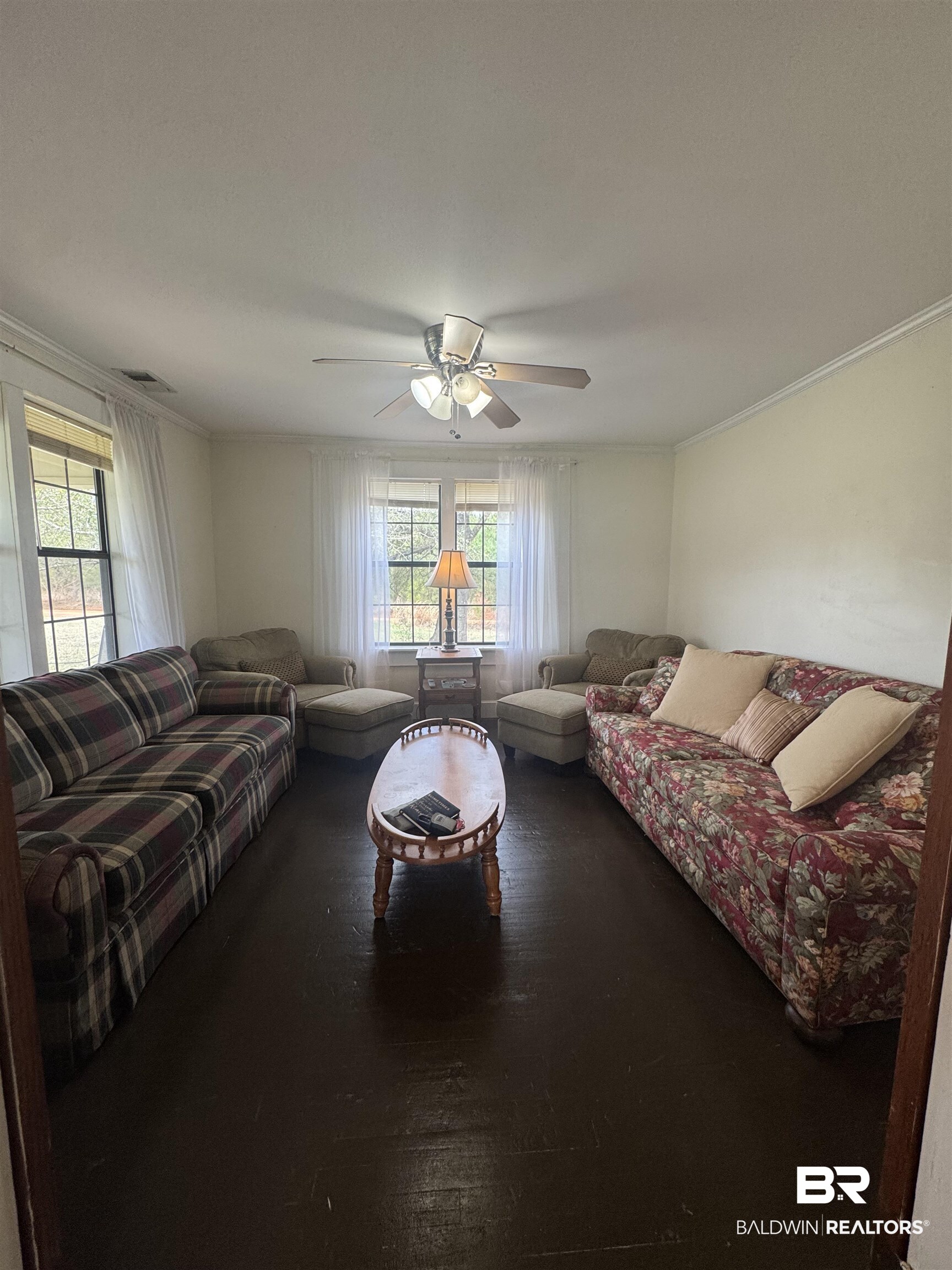 275 Thames Road Frisco City, AL 36445 - Photo 14 of 24 Living room featuring ornamental molding, a ceiling fan, visible vents, and a healthy amount of sunlight