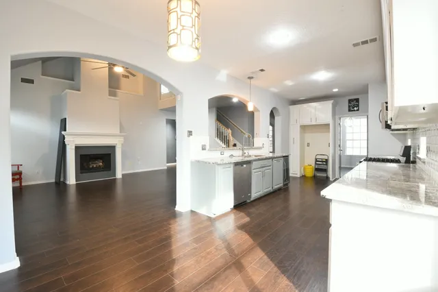 a kitchen with a sink cabinets and wooden floor