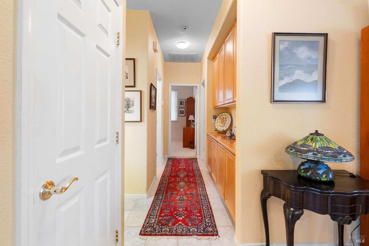 672 Meadowbrook Lane Rio Vista, CA 94571 - Photo 11 of 39 a hallway with painting on the wall and a table