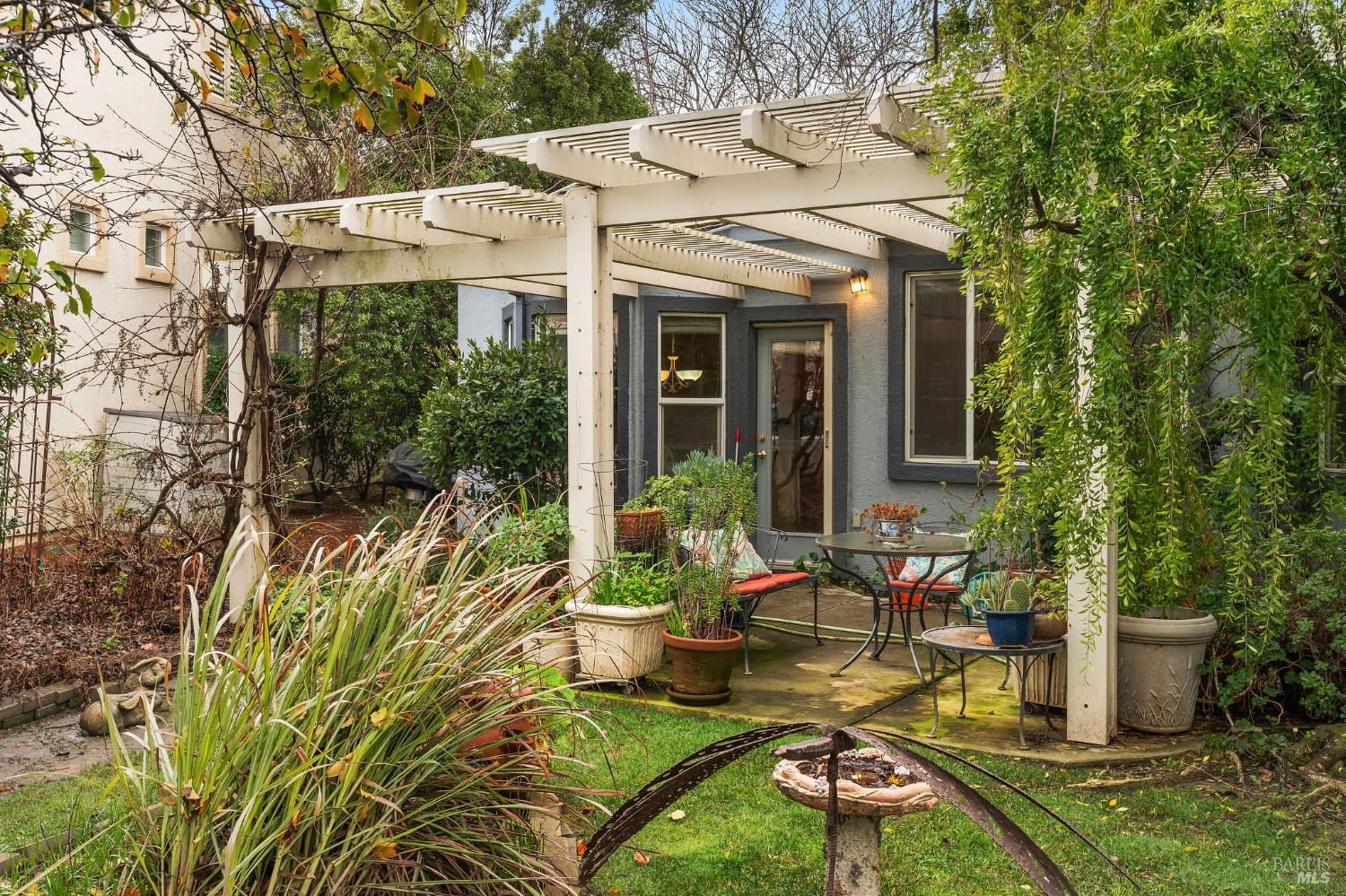 672 Meadowbrook Lane Rio Vista, CA 94571 - Photo 19 of 39 a view of a patio with table and chairs potted plants and floor to ceiling window
