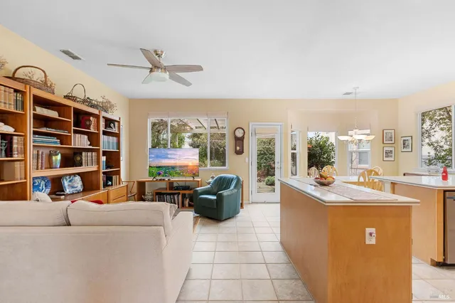 a living room with furniture and a floor to ceiling window