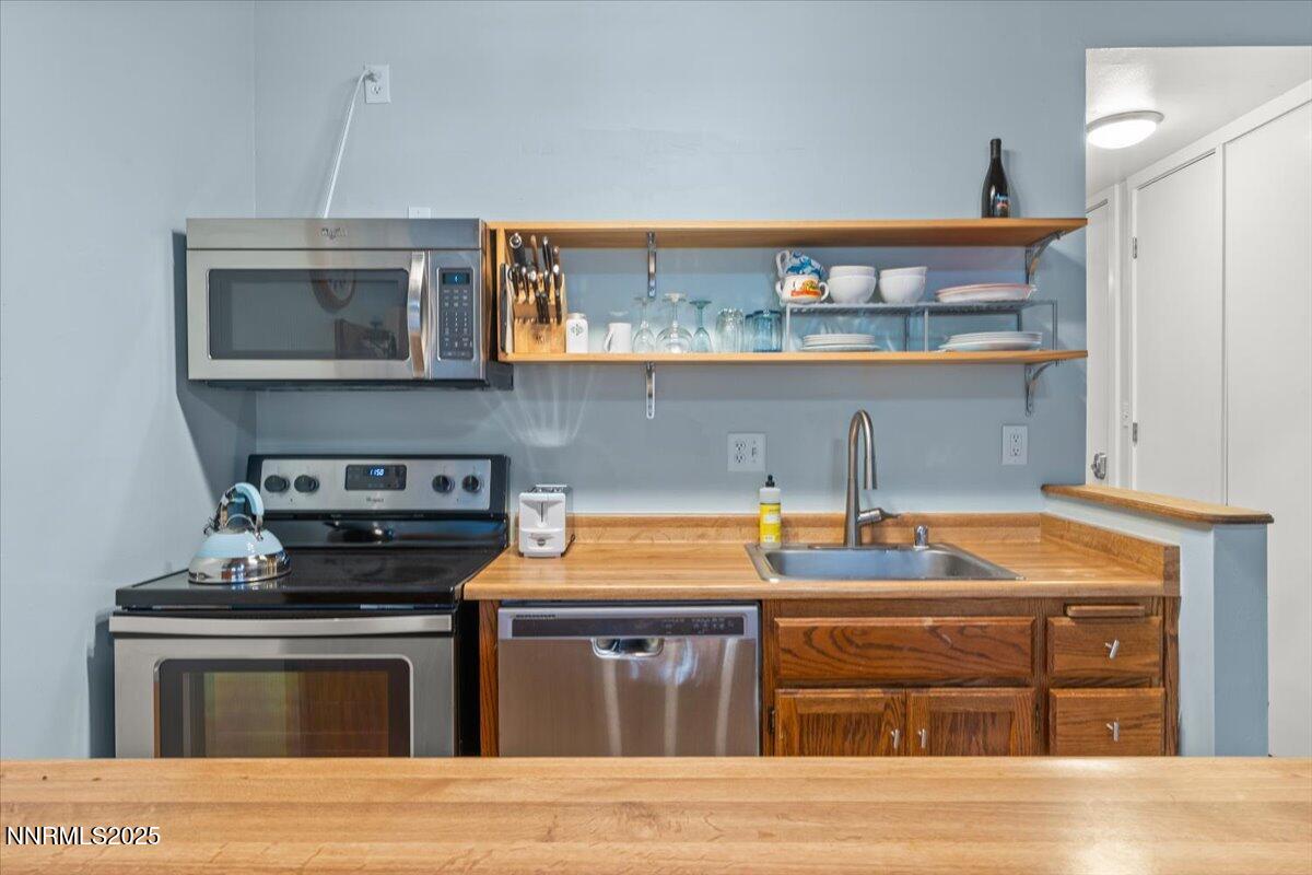 751 Tahoe Boulevard, Unit 21 Incline Village, NV 89451 - Photo 6 of 23 a kitchen with stainless steel appliances granite countertop a stove and a cabinets