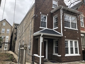 2138 West Shakespeare Avenue, Unit 1 Chicago, IL 60647 - Photo 1 of 14 a front view of a house with glass windows
