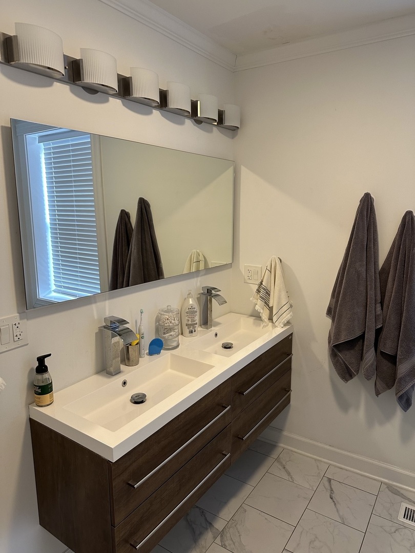 2138 West Shakespeare Avenue, Unit 1 Chicago, IL 60647 - Photo 11 of 14 a bathroom with a sink and a mirror