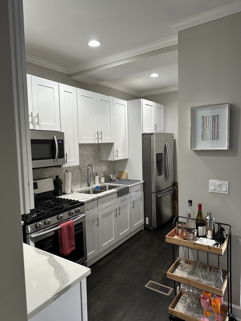 2138 West Shakespeare Avenue, Unit 1 Chicago, IL 60647 - Photo 4 of 14 a kitchen with refrigerator and stove