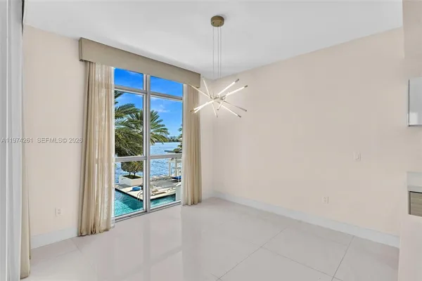 a view of a room with furniture and a window