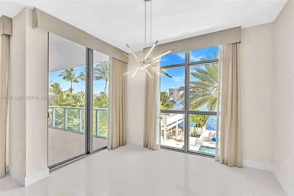 a furnished livingroom with outdoor space and windows
