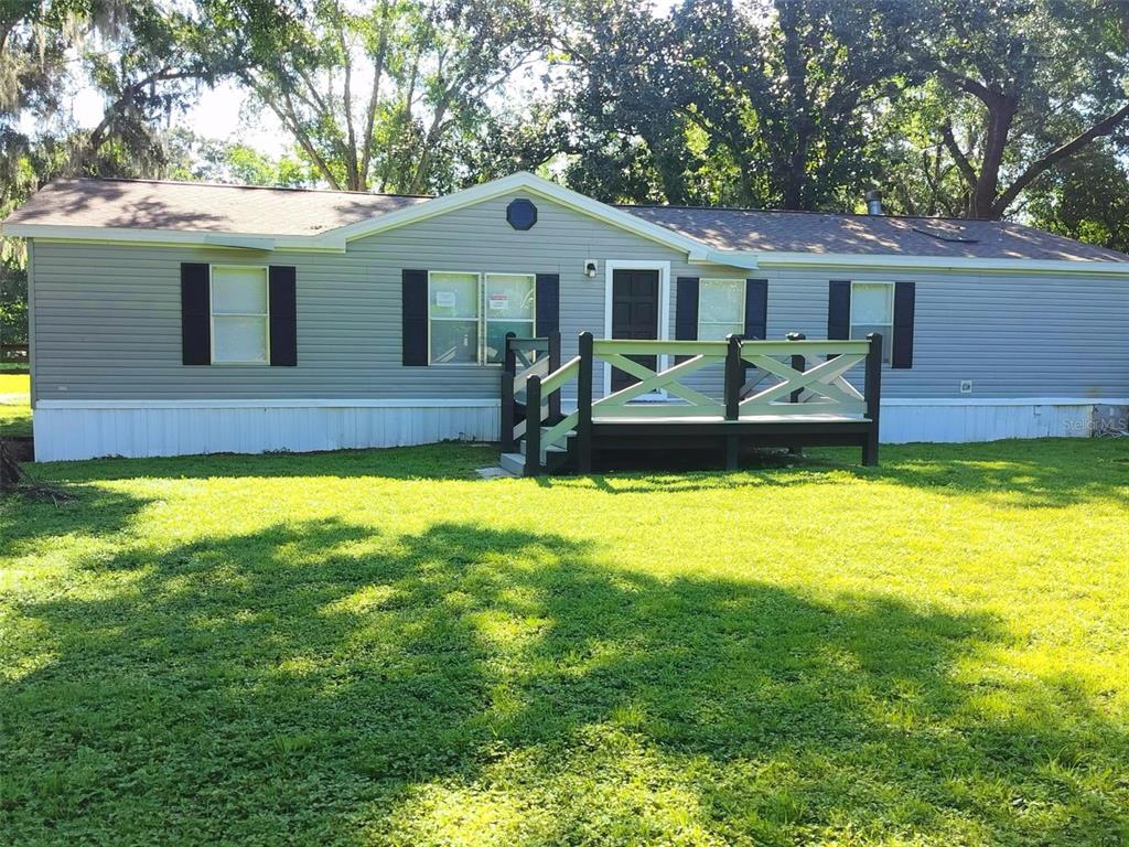 12116 Hamlin Road Spring Hill, FL 34610 - Photo 1 of 1 a front view of a house with a yard outdoor seating and yard