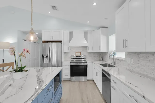 a living room with furniture and large windows
