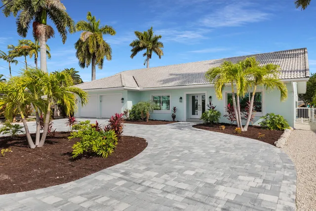 a view of swimming pool with seating area and trees around
