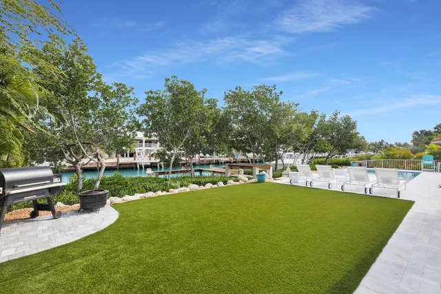 a view of a house with swimming pool and sitting area