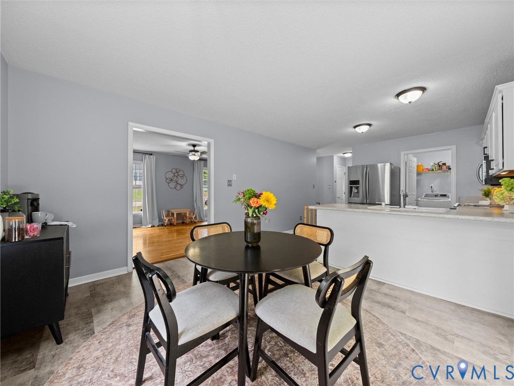 6712 Hedges Road Richmond, VA 23224 - Photo 11 of 34 Kitchen with a breakfast bar, stainless steel refr
