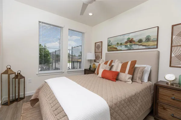 a bedroom with bed and wooden floor