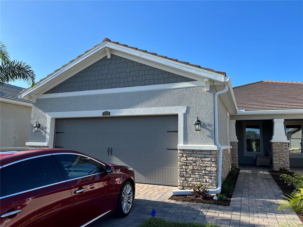 8788 Rain Song Road Sarasota, FL 34238 - Photo 1 of 2 a front view of a house with garage
