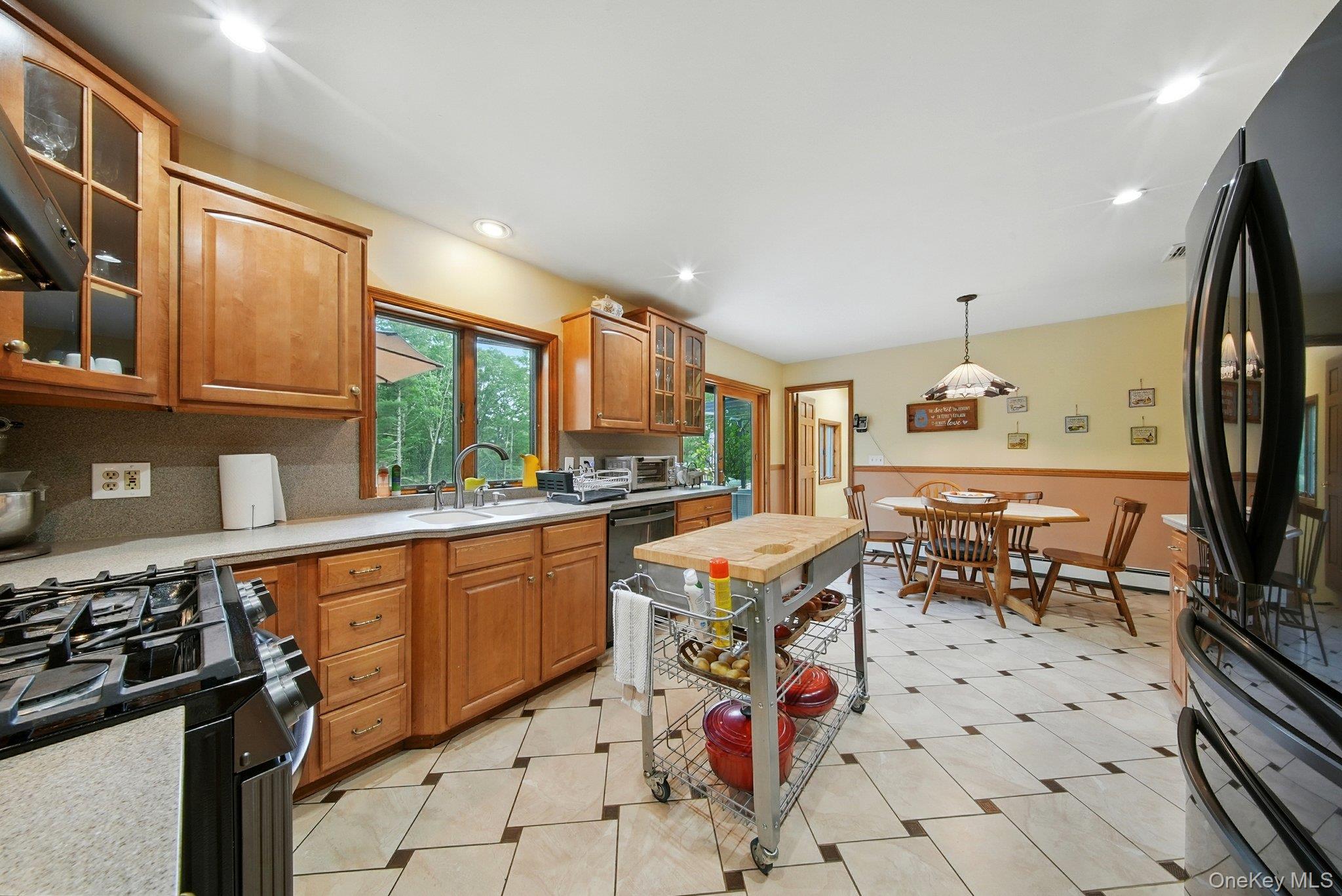 193 Dill Road Forestburgh, NY 12777 - Photo 11 of 31 Kitchen with freestanding refrigerator, light countertops, gas range oven, dishwasher, and hanging light fixtures
