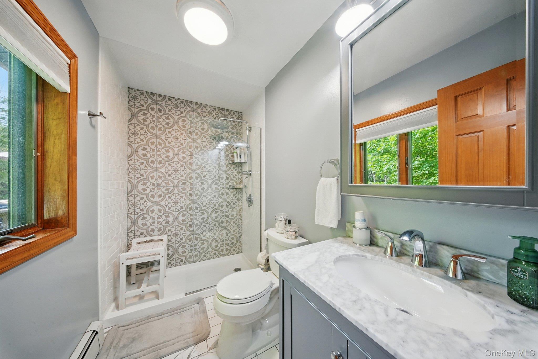 193 Dill Road Forestburgh, NY 12777 - Photo 18 of 31 Bathroom with vanity, a shower stall, and baseboard heating