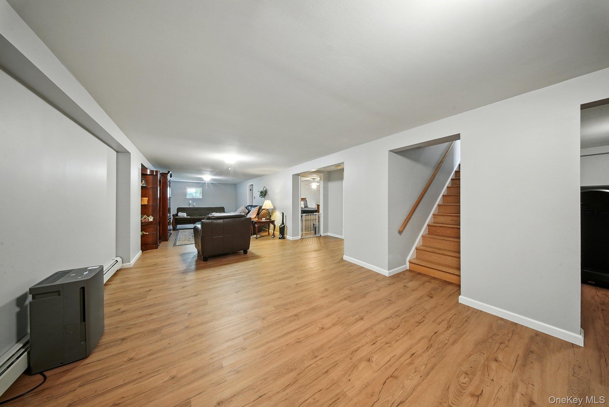 193 Dill Road Forestburgh, NY 12777 - Photo 19 of 31 Living area with light wood-type flooring, stairway, and baseboard heating