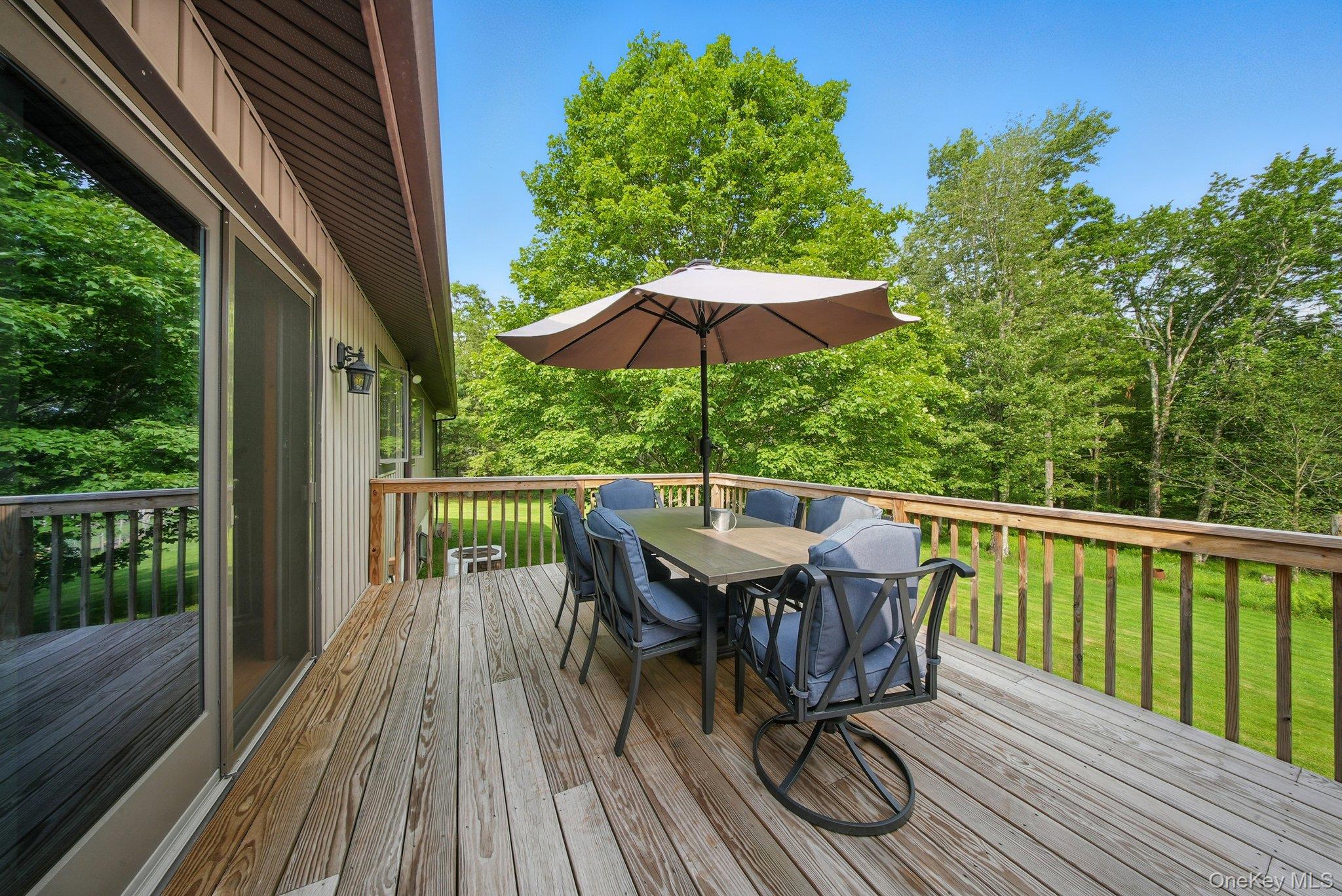 193 Dill Road Forestburgh, NY 12777 - Photo 26 of 31 Wooden terrace with outdoor dining area and a lawn
