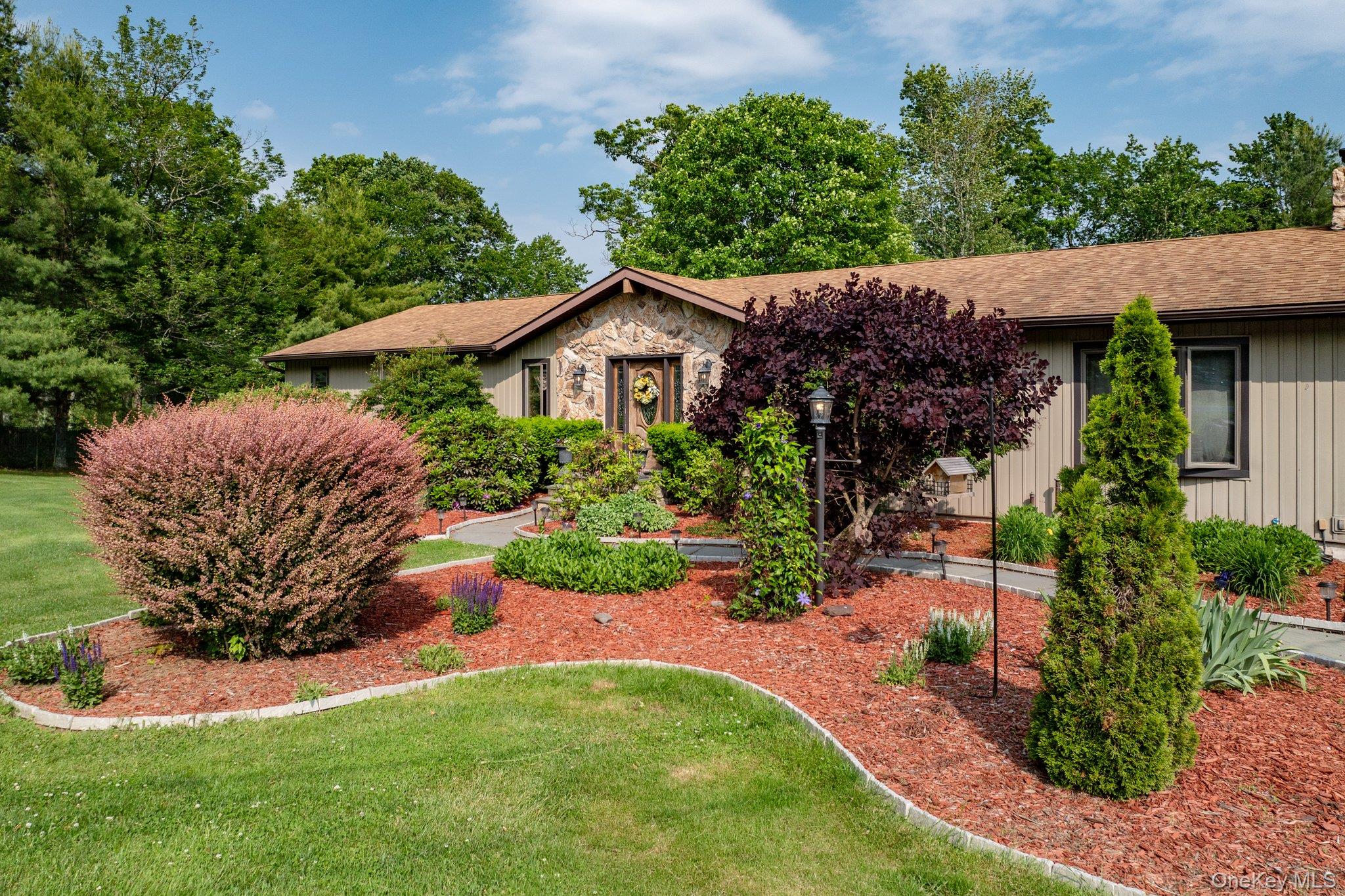 193 Dill Road Forestburgh, NY 12777 - Photo 3 of 31 View of front of house with a front lawn, roof with shingles, board and batten siding, a chimney, and stone siding