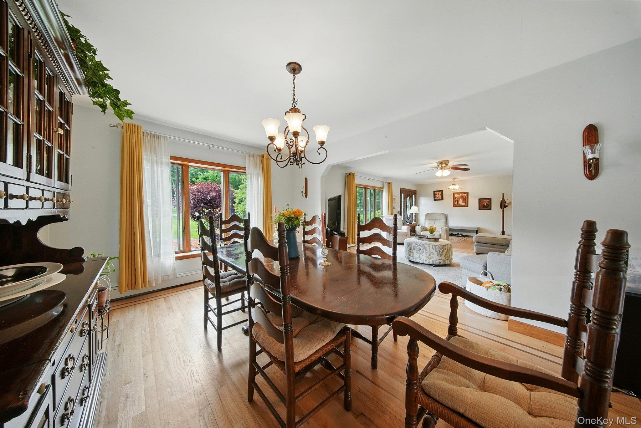 193 Dill Road Forestburgh, NY 12777 - Photo 8 of 31 Dining space featuring light wood-type flooring, a chandelier, and a ceiling fan