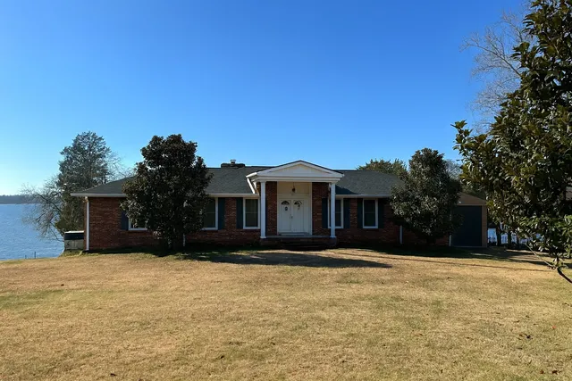 a front view of house with yard and trees