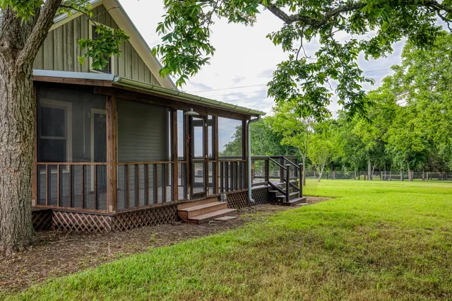 a view of backyard with deck and outdoor seating