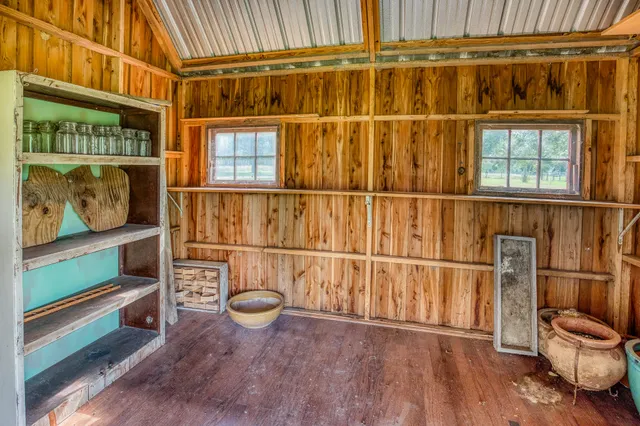 a view of a room with wooden floor and windows
