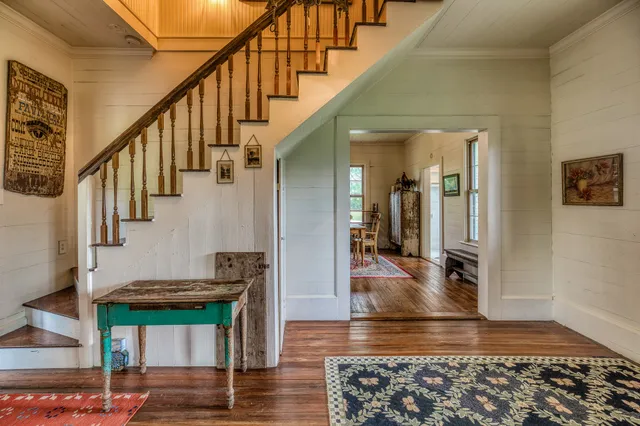 a view of entryway and hall with wooden floor