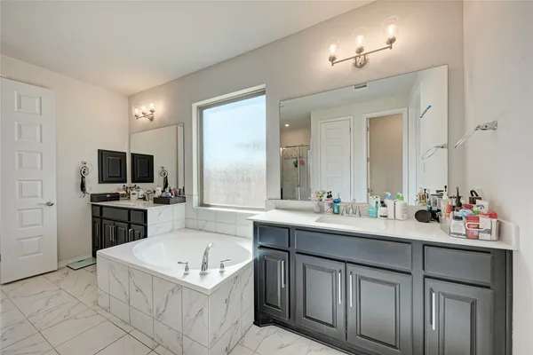 a bedroom with a bed and a dresser with wooden floor