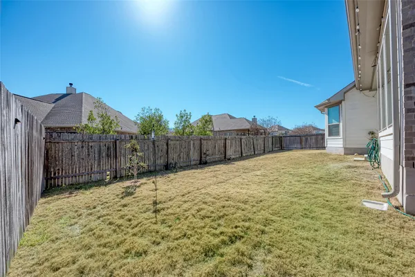 a backyard of a house with table and chairs